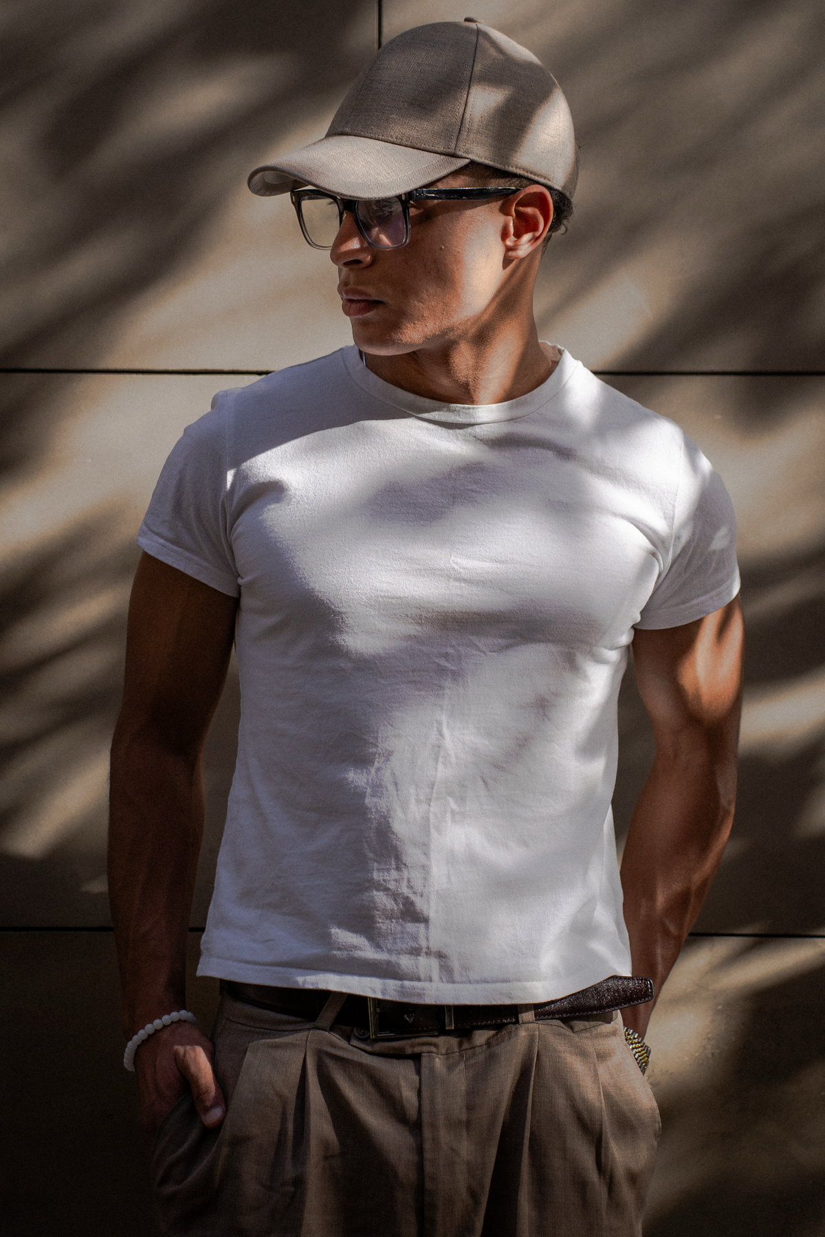 Model wearing a Linea cap in soft architectural shadows